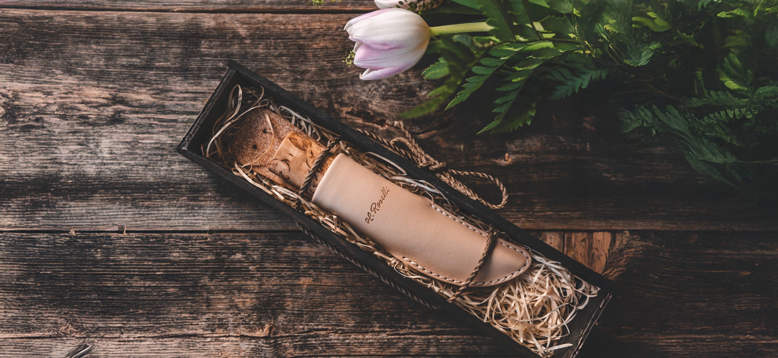 Roselli handmade knife in leather sheath laying in black gift box 