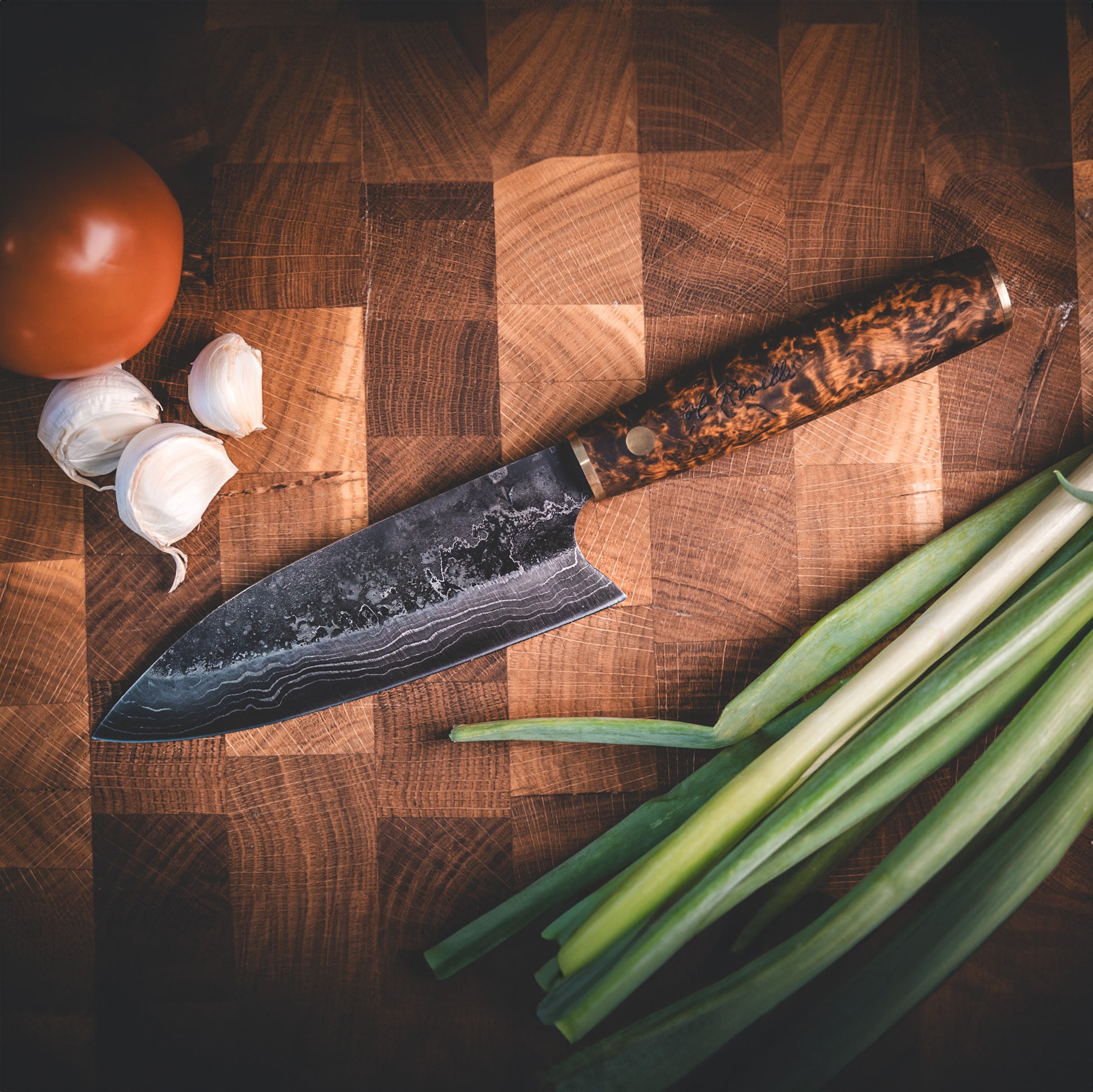 Handmade Damascus steel kitchen knife made by hand in our factory in Finland. The Damascus steel has 37 layers of steel. Comes with a handle made from stained curly birch and a handmade leather sheath.