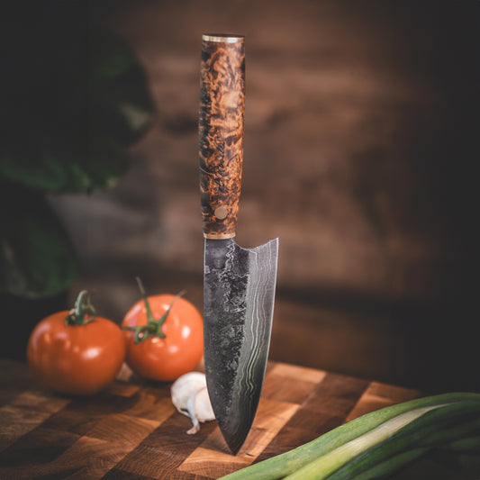 Handmade Damascus steel kitchen knife made by hand in our factory in Finland. The Damascus steel has 37 layers of steel. Comes with a handle made from stained curly birch and a handmade leather sheath.